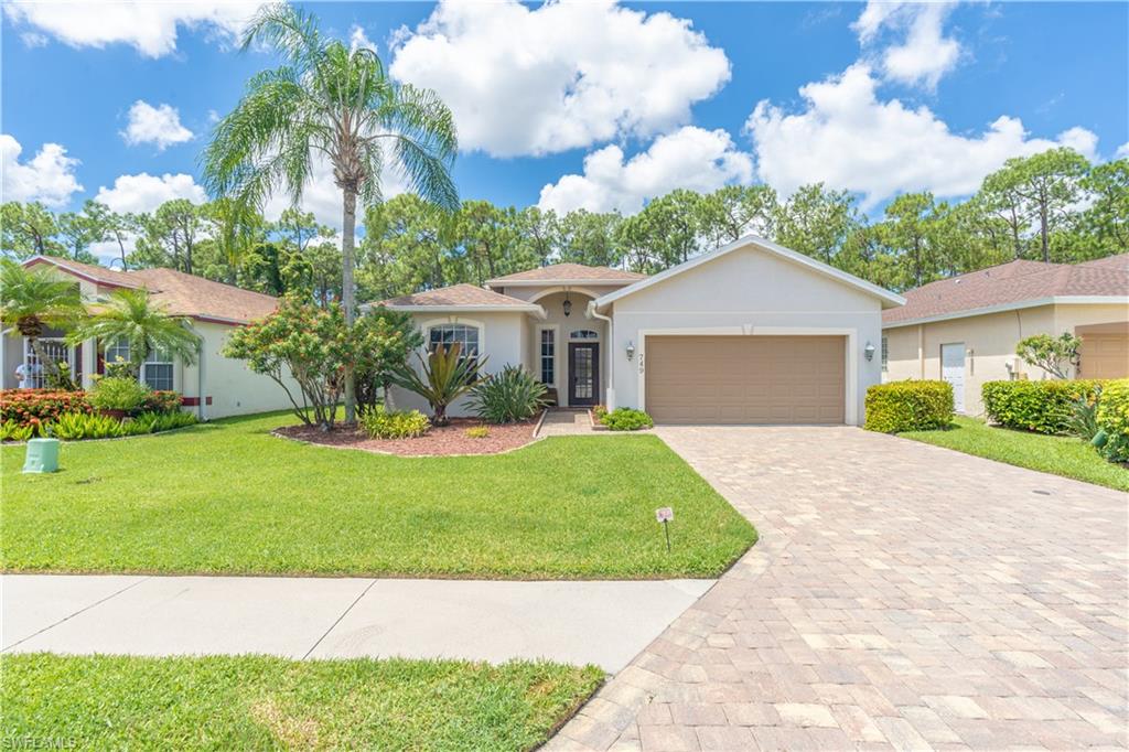 749 Crossfield Circle Naples, FL 34104 - Photo 3 of 37 a front view of a house with garden