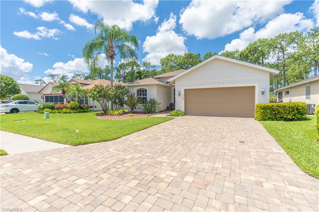 749 Crossfield Circle Naples, FL 34104 - Photo 4 of 37 a view of white house with a yard and potted plants