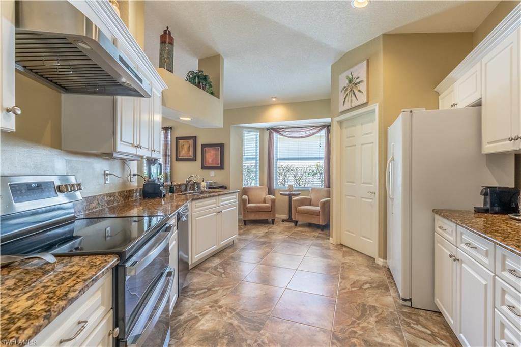 749 Crossfield Circle Naples, FL 34104 - Photo 5 of 37 a kitchen with a sink stove and refrigerator