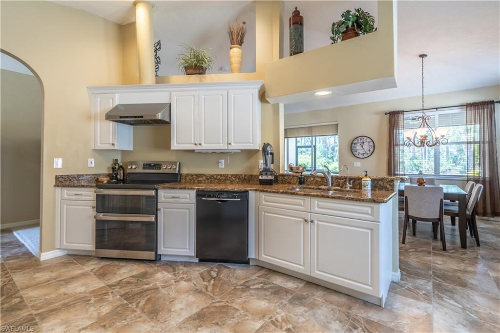 749 Crossfield Circle Naples, FL 34104 - Photo 7 of 37 a kitchen with stainless steel appliances granite countertop a stove a sink and a refrigerator