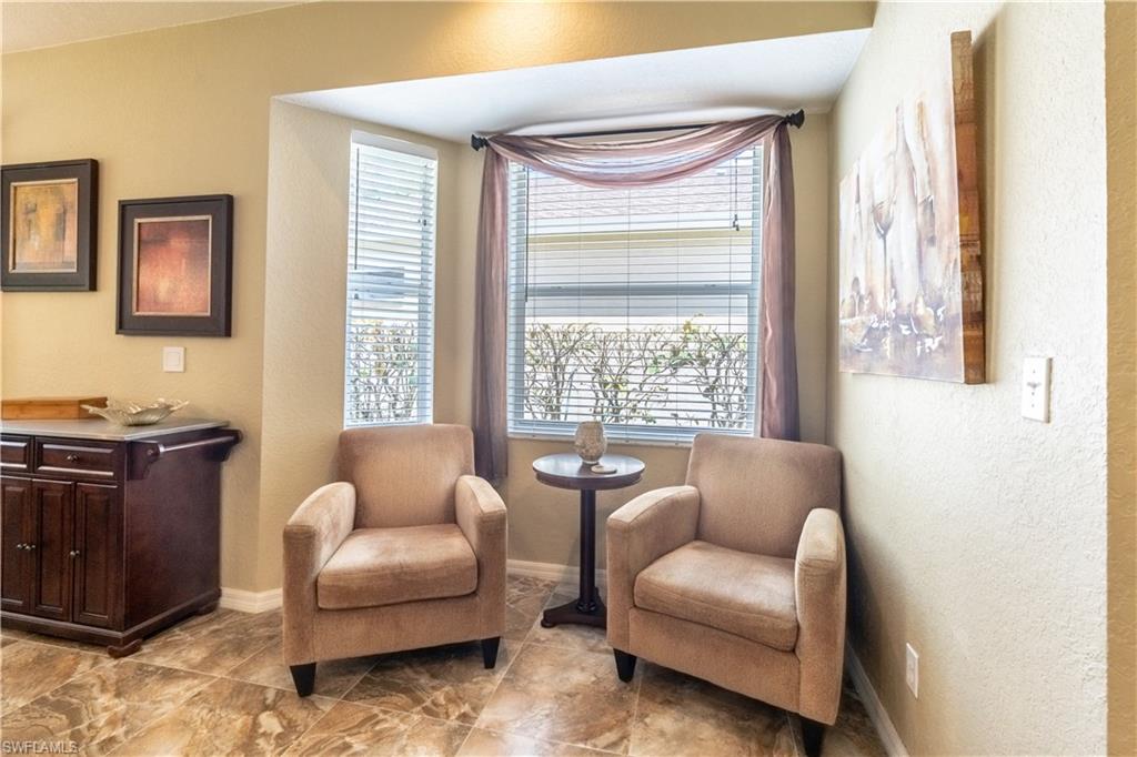 749 Crossfield Circle Naples, FL 34104 - Photo 8 of 37 a living room with furniture and a window