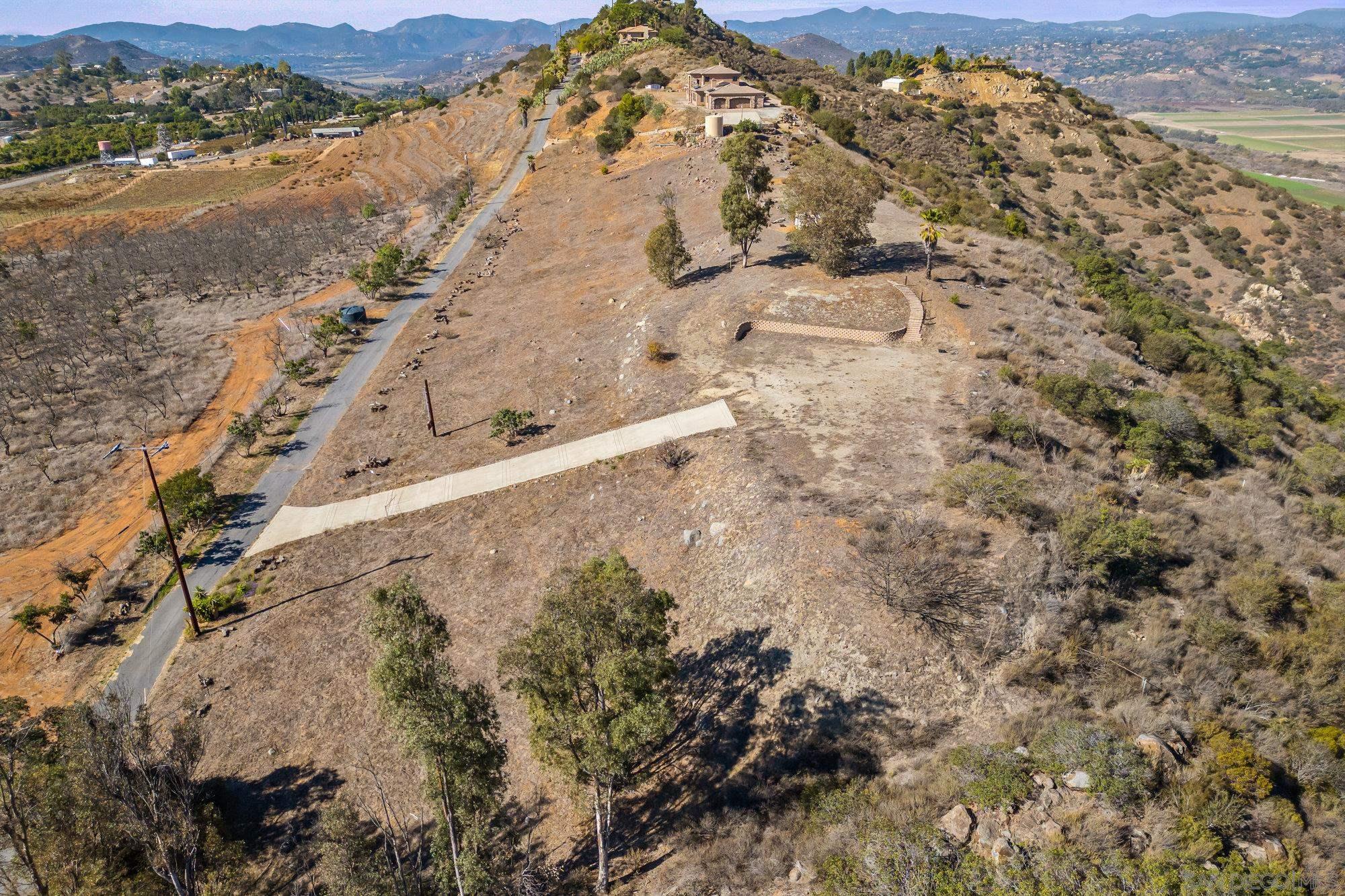 15840 Highland Valley Road Escondido, CA 92025 - Photo 12 of 18 a view of a dry yard with mountains