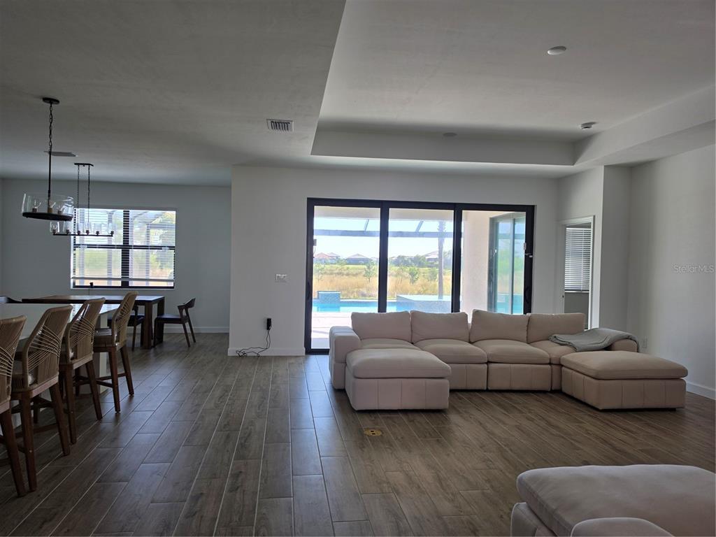 18334 Ridgeline Drive Estero, FL 33928 - Photo 5 of 30 a living room with furniture and a large window