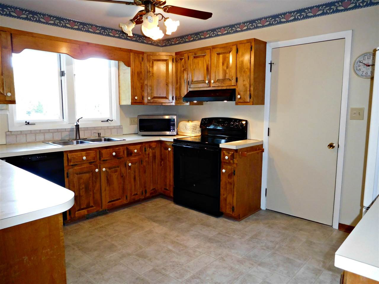 2217 Timberlake Drive Raleigh, NC 27604 - Photo 4 of 22 Newer appliances and solid wood cabinets! Door next to stove leads to 420 sf of heated and cooled storage. Could be a great bonus room/office/man cave/she shed... LOL whatever you want it to be! Kitchen