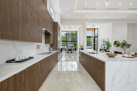 a large kitchen with stainless steel appliances a lot of counter space and a sink