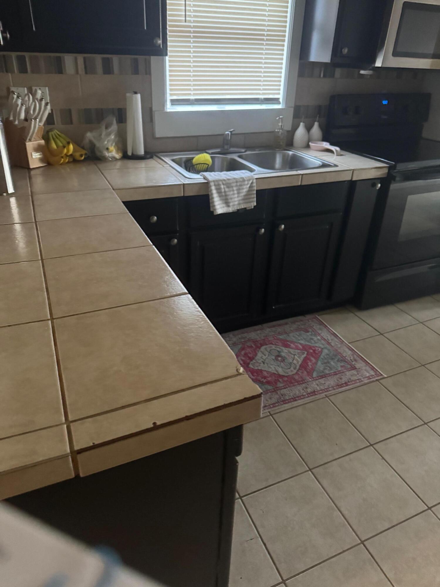 2312 15th Street Lubbock, TX 79401 - Photo 5 of 20 a kitchen with a sink and a stove