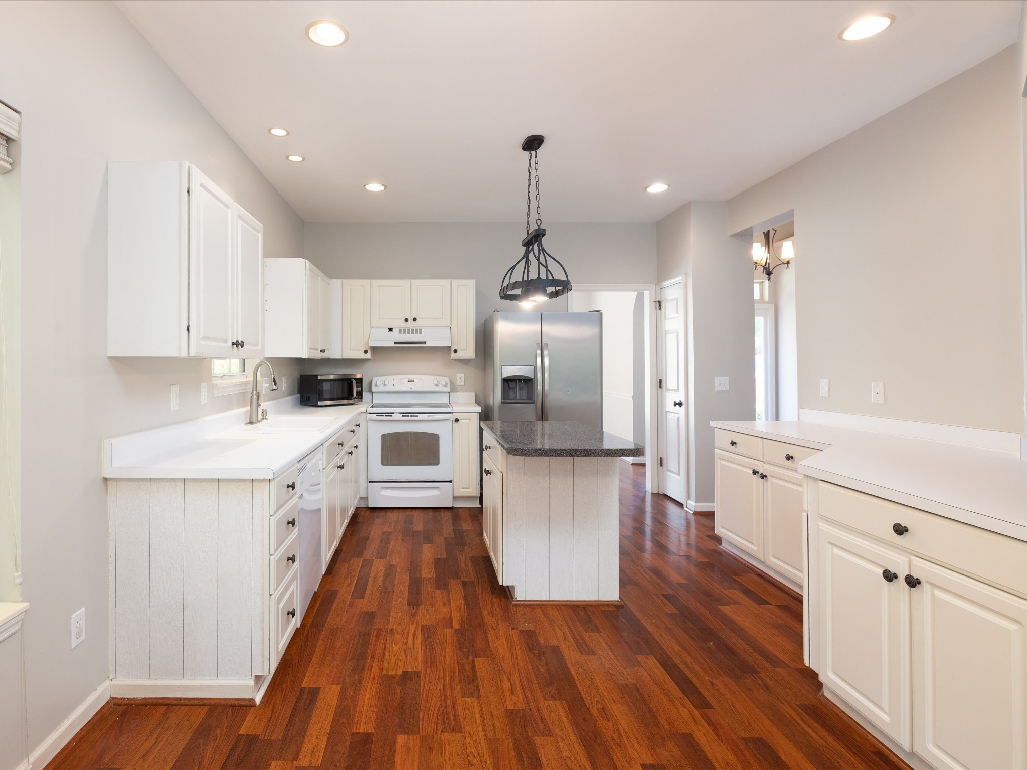 4629 Sandy Creek Road Nashville, TN 37221 - Photo 12 of 48 a kitchen with white cabinets and stainless steel appliances