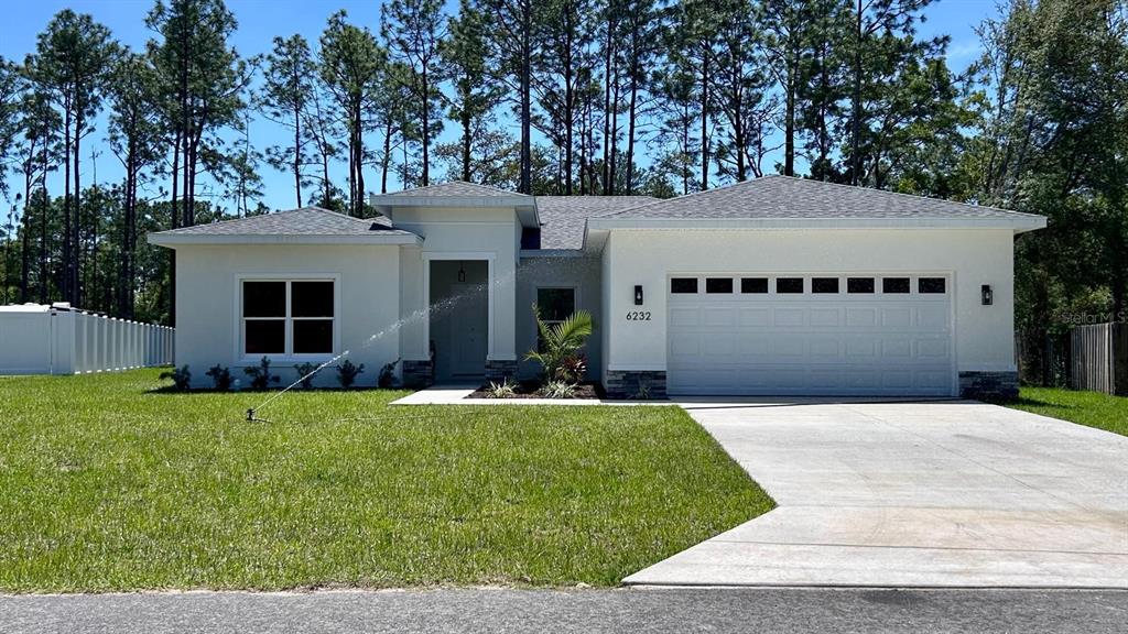 6232 Southwest 134th Loop Ocala, FL 34473 - Photo 1 of 1 a front view of a house with a yard