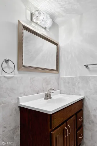 a bathroom with a sink vanity and a mirror