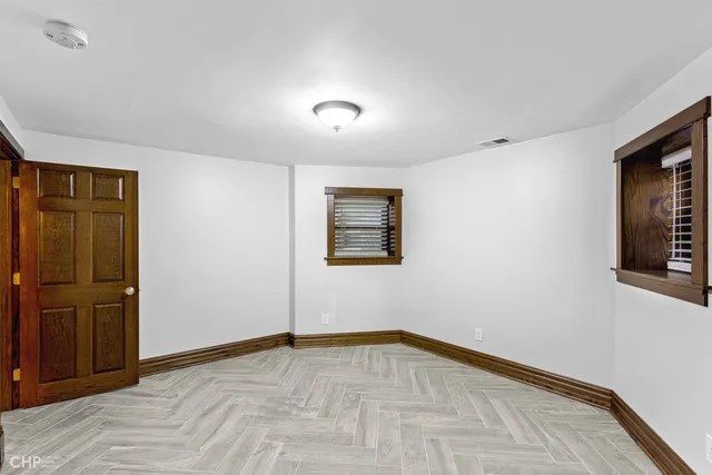 a bathroom with a granite countertop toilet a sink and a mirror