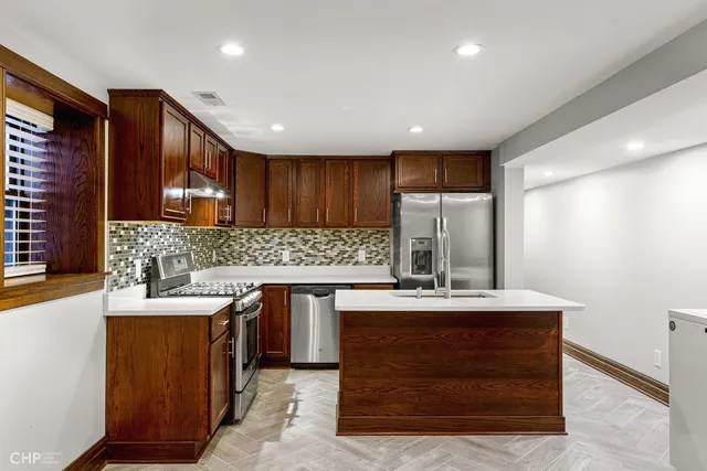 a kitchen with a sink stove and cabinets