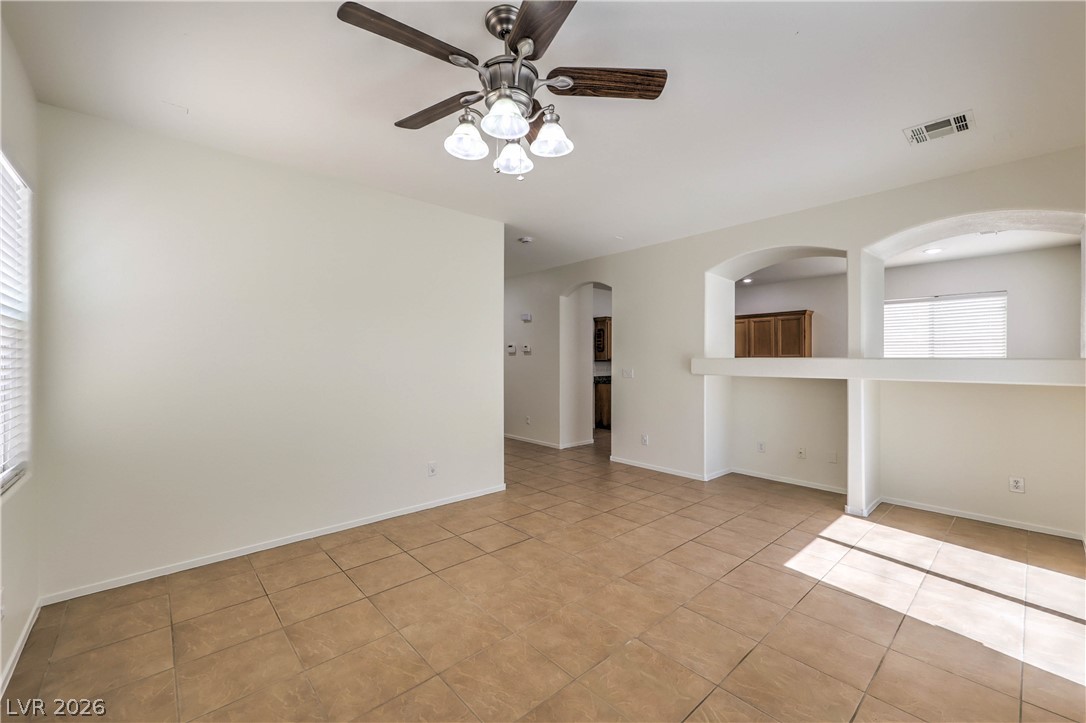 10939 Paradise Road Henderson, NV 89052 - Photo 15 of 36 A versatile living space features practical tiled flooring and an overhead ceiling fan.