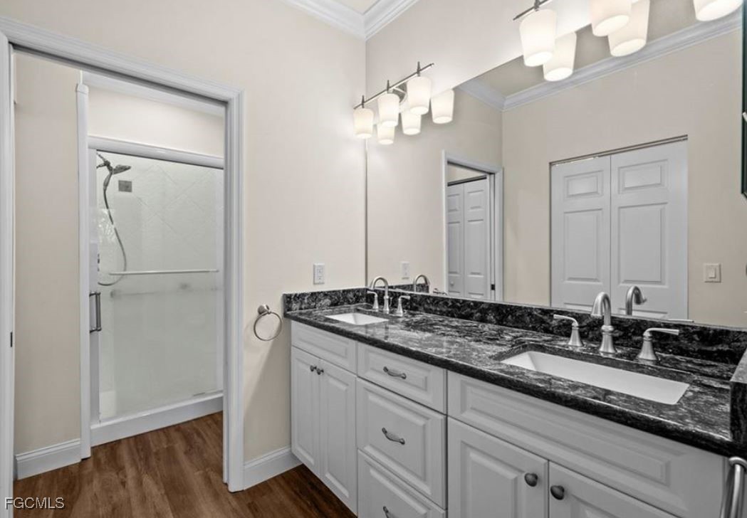 14970 Vista View Way, Unit 304 Fort Myers, FL 33919 - Photo 11 of 37 a bathroom with a granite countertop sink a mirror and a vanity