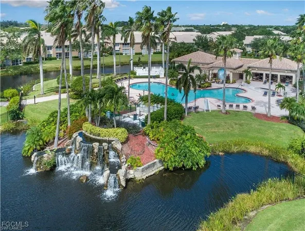 an aerial view of a house with a yard and outdoor seating