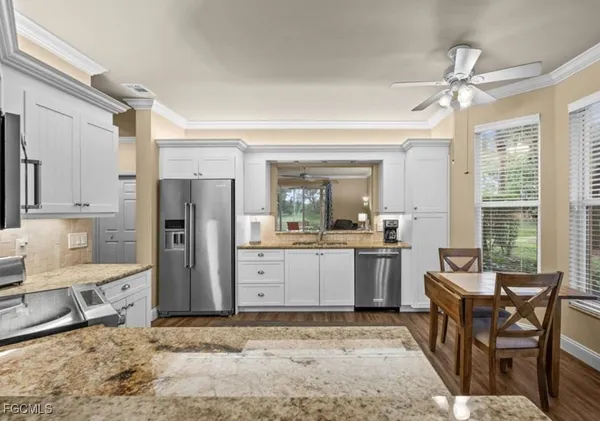 a kitchen with refrigerator cabinets and dining table