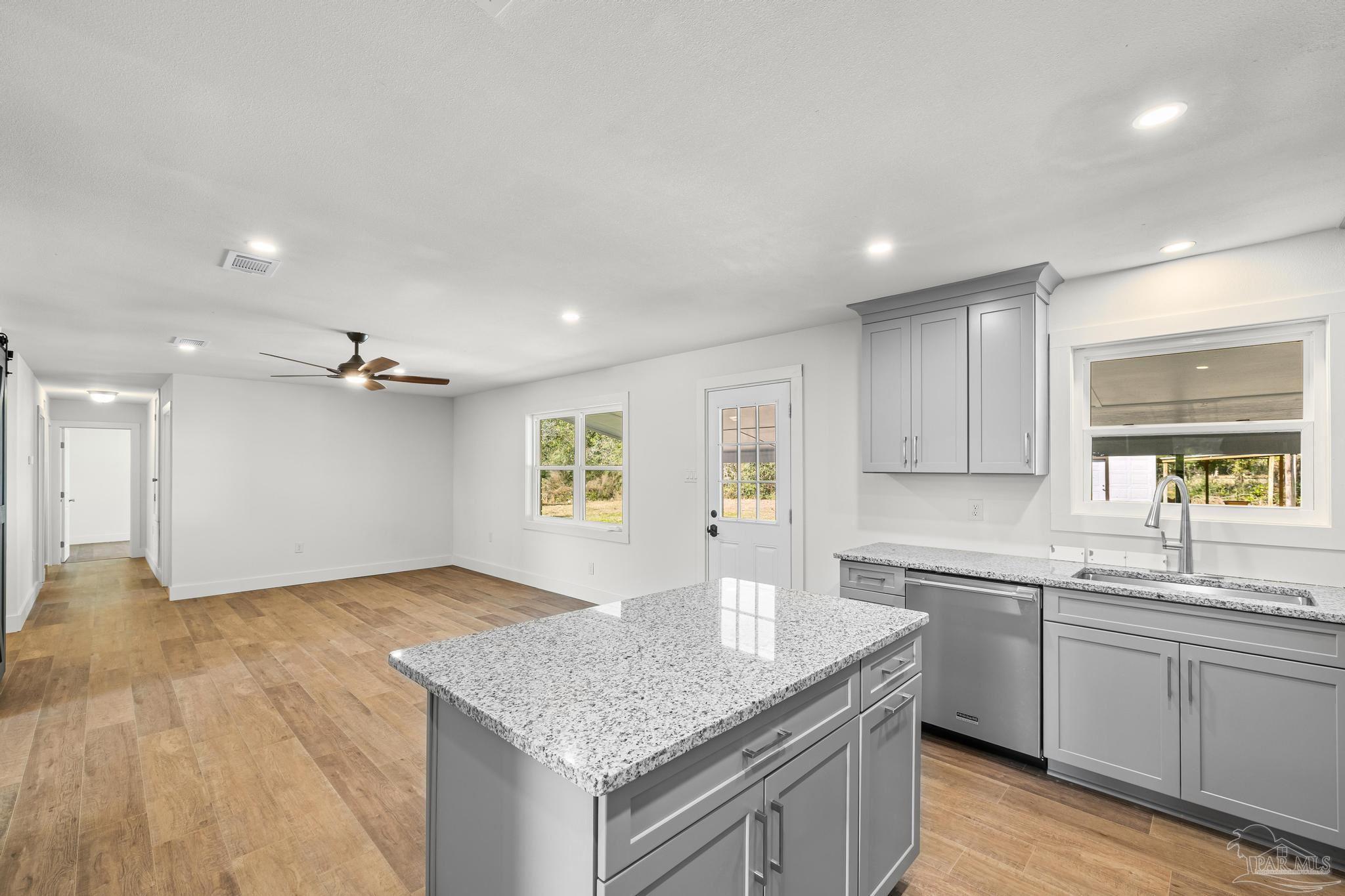 7988 Malone Road Milton, FL 32570 - Photo 14 of 69 a kitchen with a sink cabinets and window