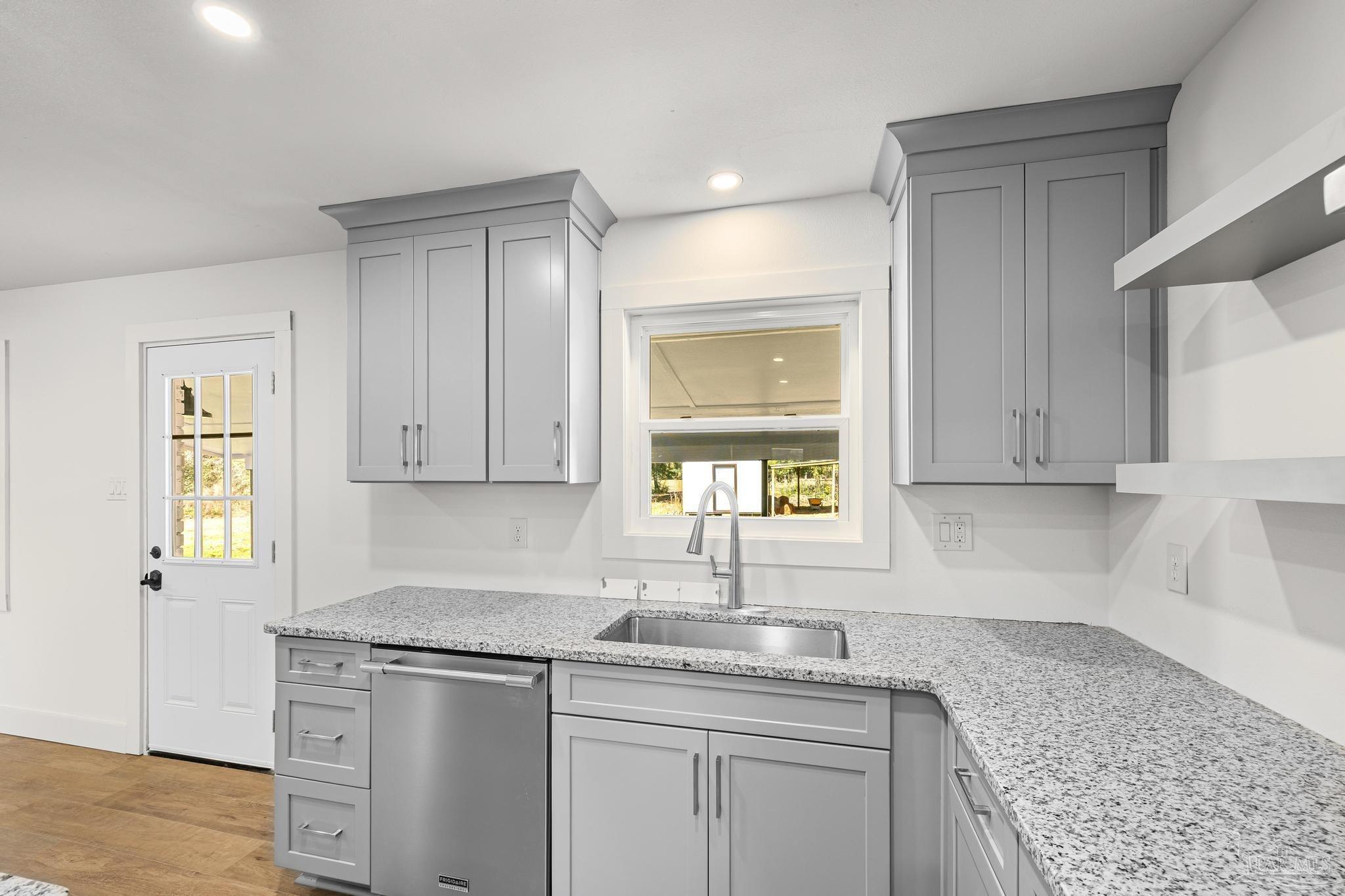 7988 Malone Road Milton, FL 32570 - Photo 16 of 69 a kitchen with stainless steel appliances granite countertop a sink stove and cabinets