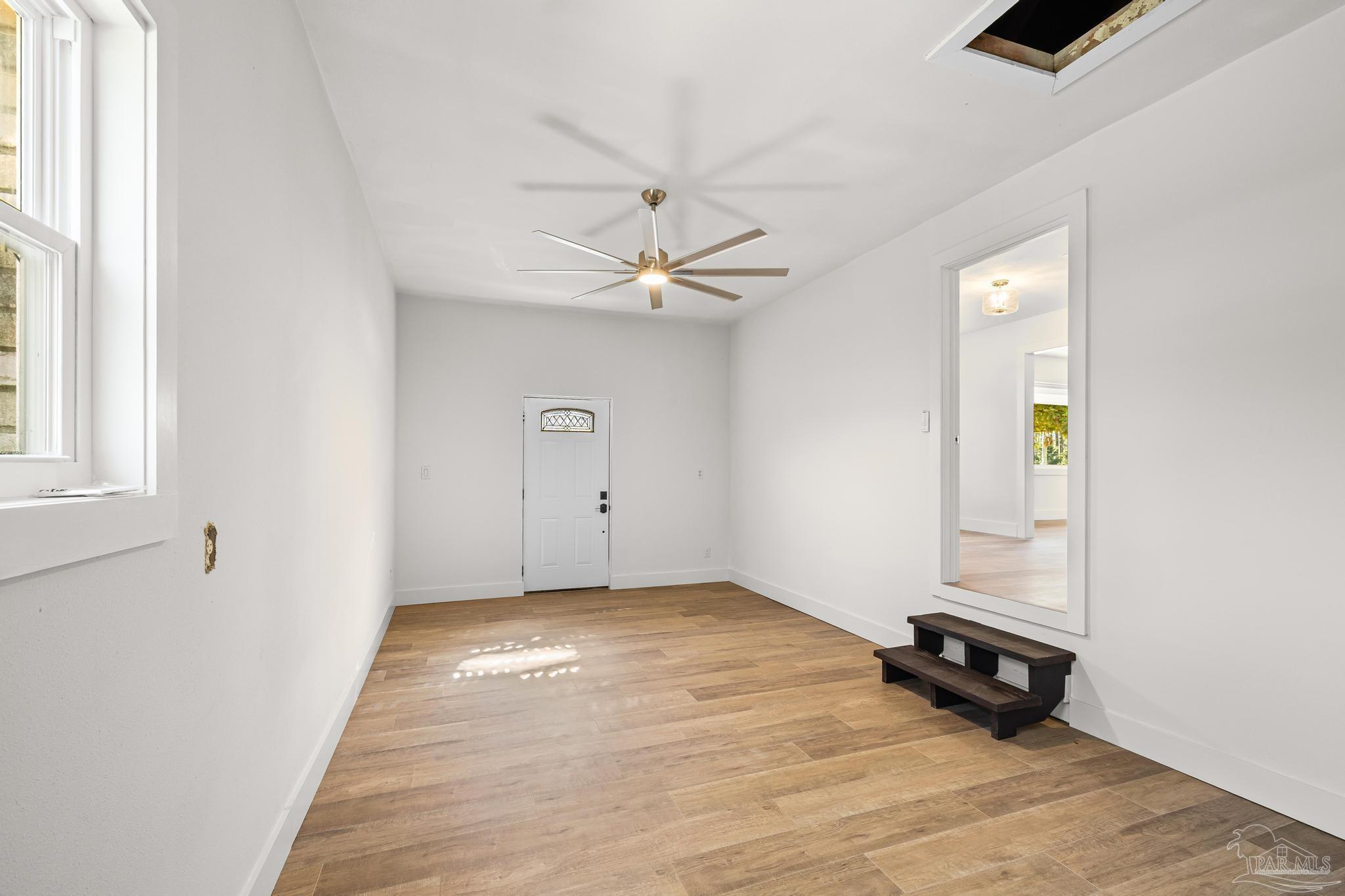 7988 Malone Road Milton, FL 32570 - Photo 22 of 69 an empty room with windows and ceiling fan
