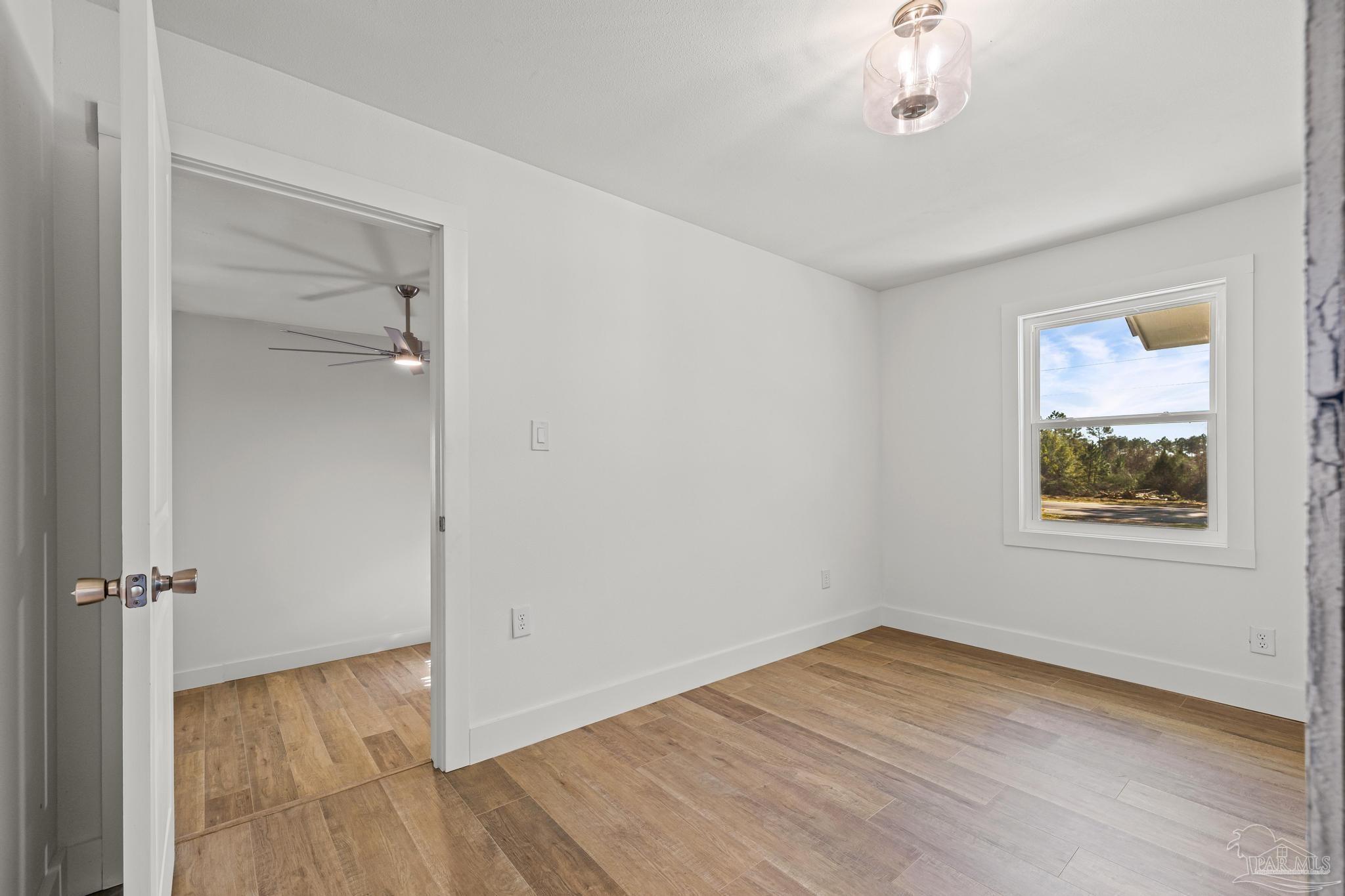 7988 Malone Road Milton, FL 32570 - Photo 24 of 69 wooden floor in an empty room with a window