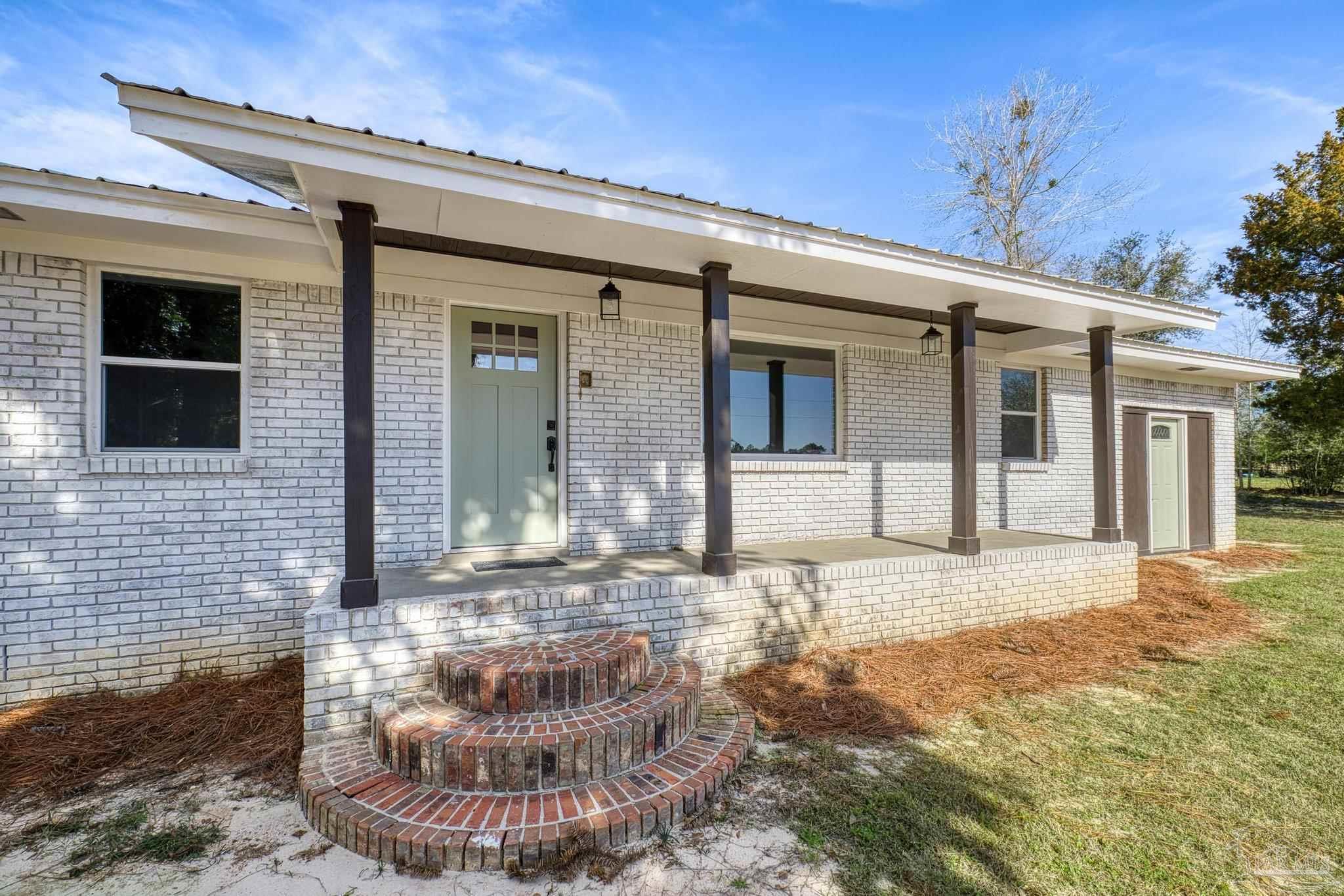 7988 Malone Road Milton, FL 32570 - Photo 4 of 69 a view of a house with a yard
