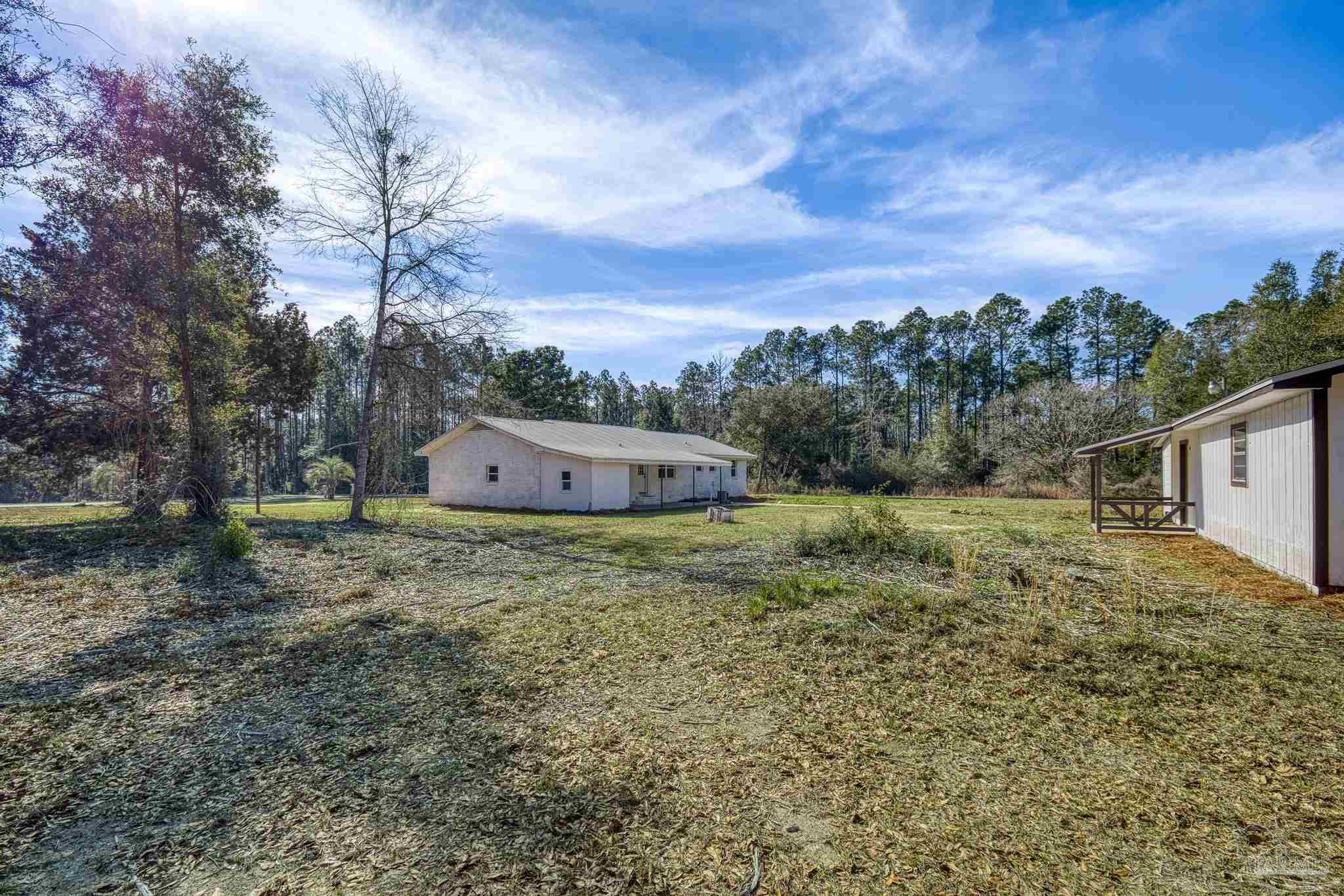 7988 Malone Road Milton, FL 32570 - Photo 46 of 69 a backyard of a house with lots of green space