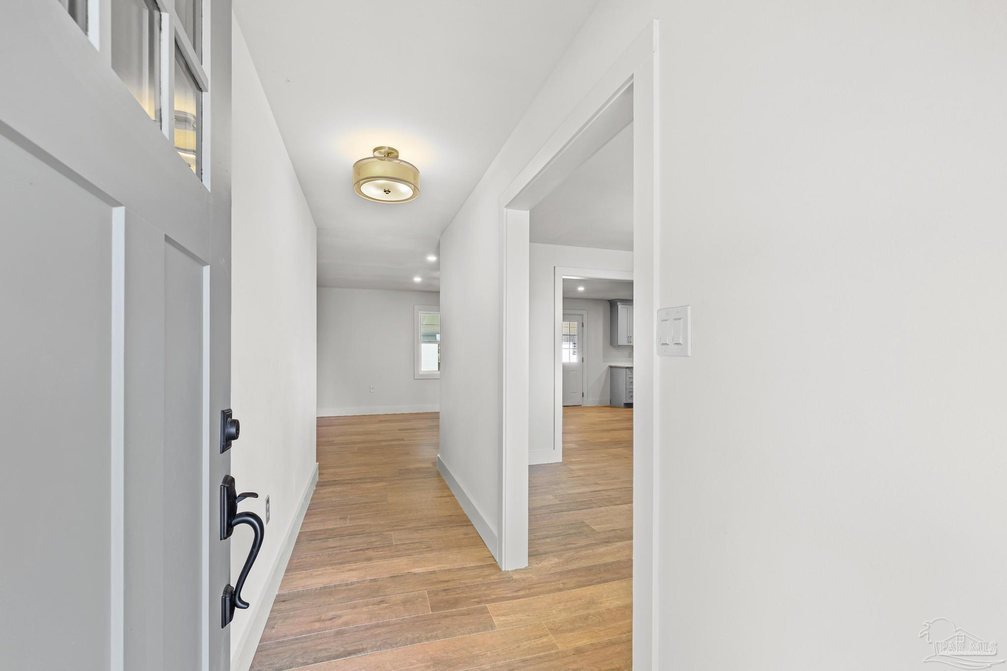7988 Malone Road Milton, FL 32570 - Photo 5 of 69 a view of a hallway view with wooden floor and staircase
