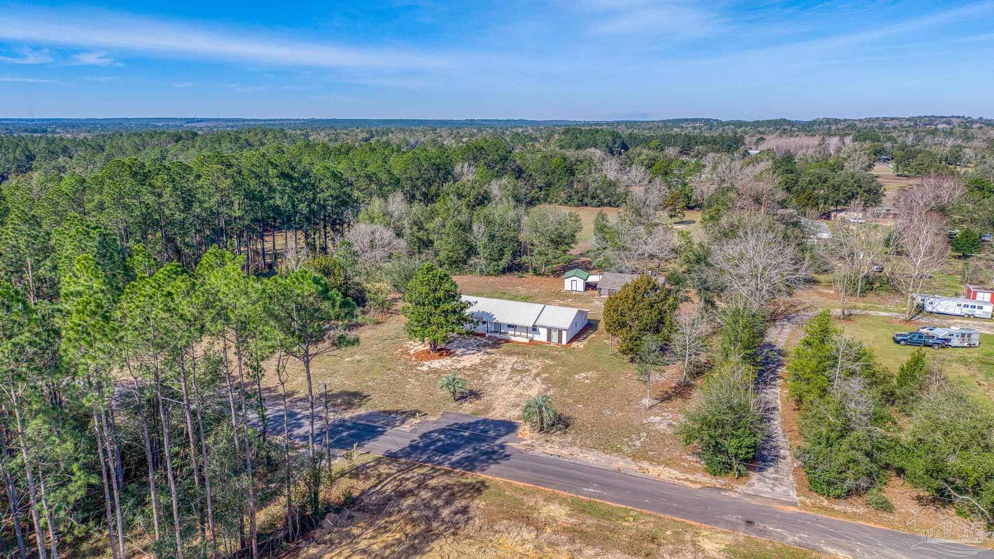 7988 Malone Road Milton, FL 32570 - Photo 61 of 69 a view of a city with lush green forest