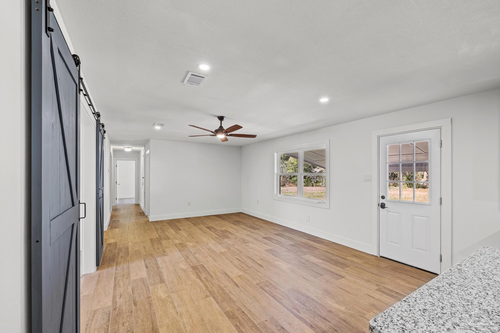 7988 Malone Road Milton, FL 32570 - Photo 10 of 69 wooden floor in an empty room with a window