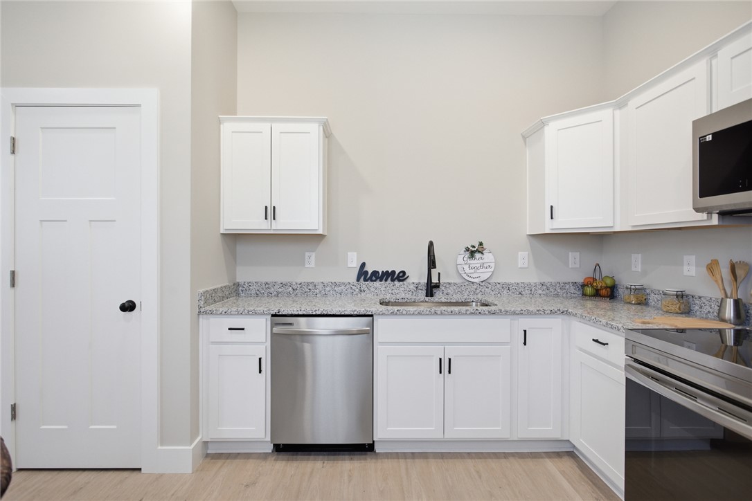 216 South Stribling Street Seneca, SC 29678 - Photo 12 of 38 This modern kitchen features bright cabinetry and durable countertops, offering a pristine and functional space.