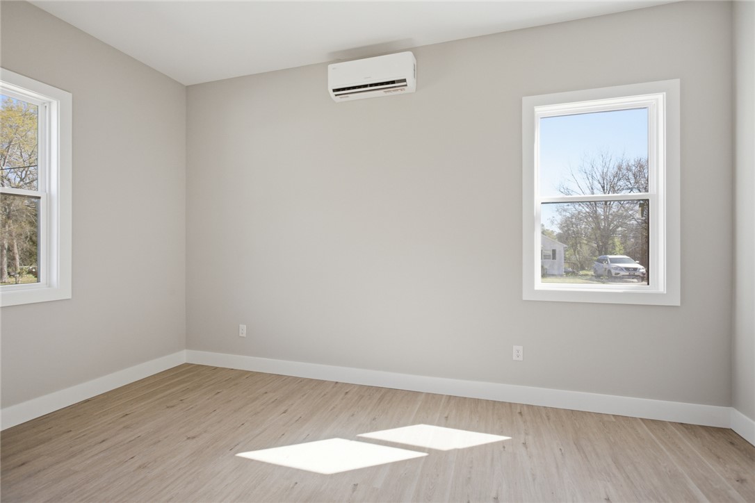 216 South Stribling Street Seneca, SC 29678 - Photo 19 of 38 Bright and airy, this room features expansive windows and durable flooring, ready for your personal touch.