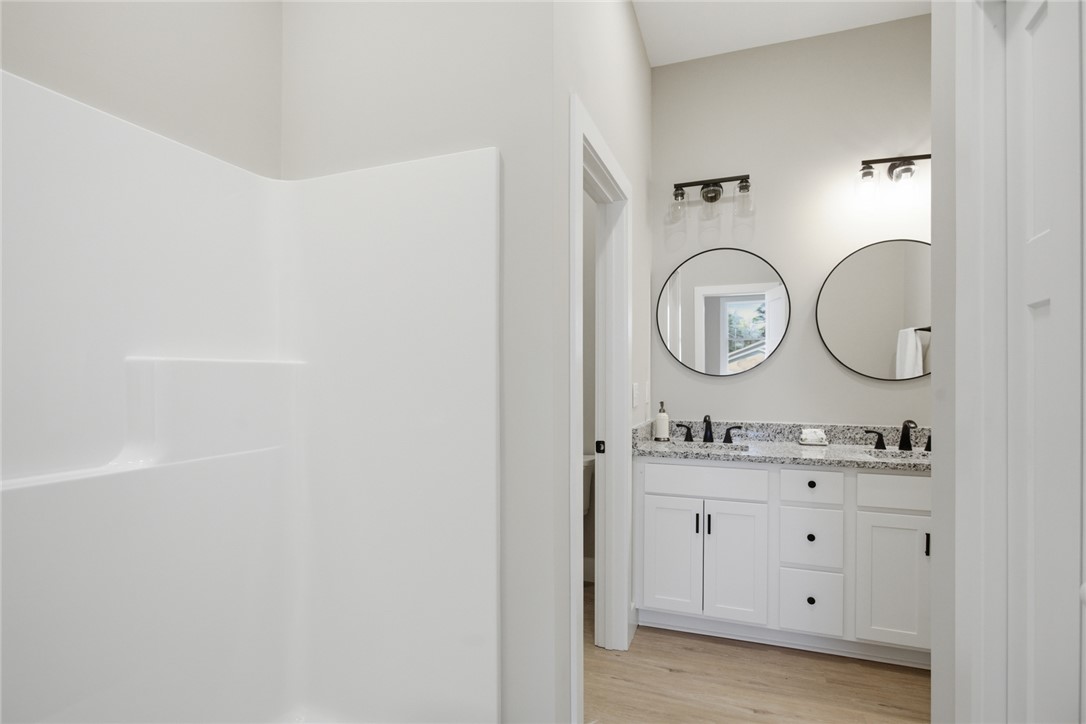 216 South Stribling Street Seneca, SC 29678 - Photo 20 of 38 This bright bathroom features a spacious shower and a vanity with dual sinks.