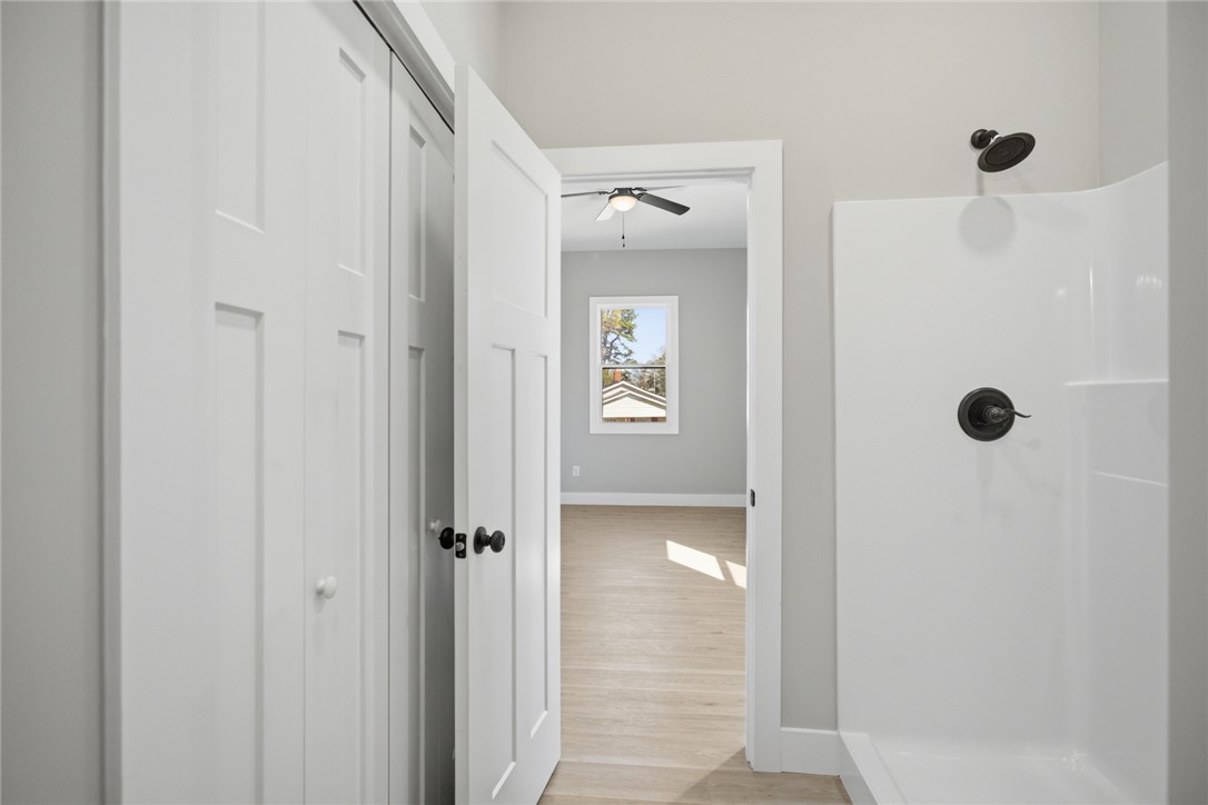 216 South Stribling Street Seneca, SC 29678 - Photo 22 of 38 This serene bedroom offers a bright window and seamless access to a well-appointed shower.