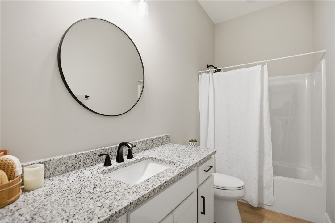 216 South Stribling Street Seneca, SC 29678 - Photo 26 of 38 This bathroom features sleek design with granite counters, modern fixtures, and a clean, bright aesthetic.