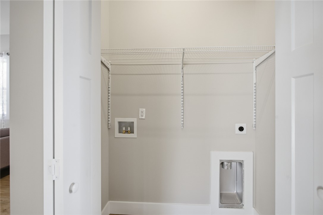 216 South Stribling Street Seneca, SC 29678 - Photo 27 of 38 This dedicated laundry space offers convenience with essential hookups and practical shelving.