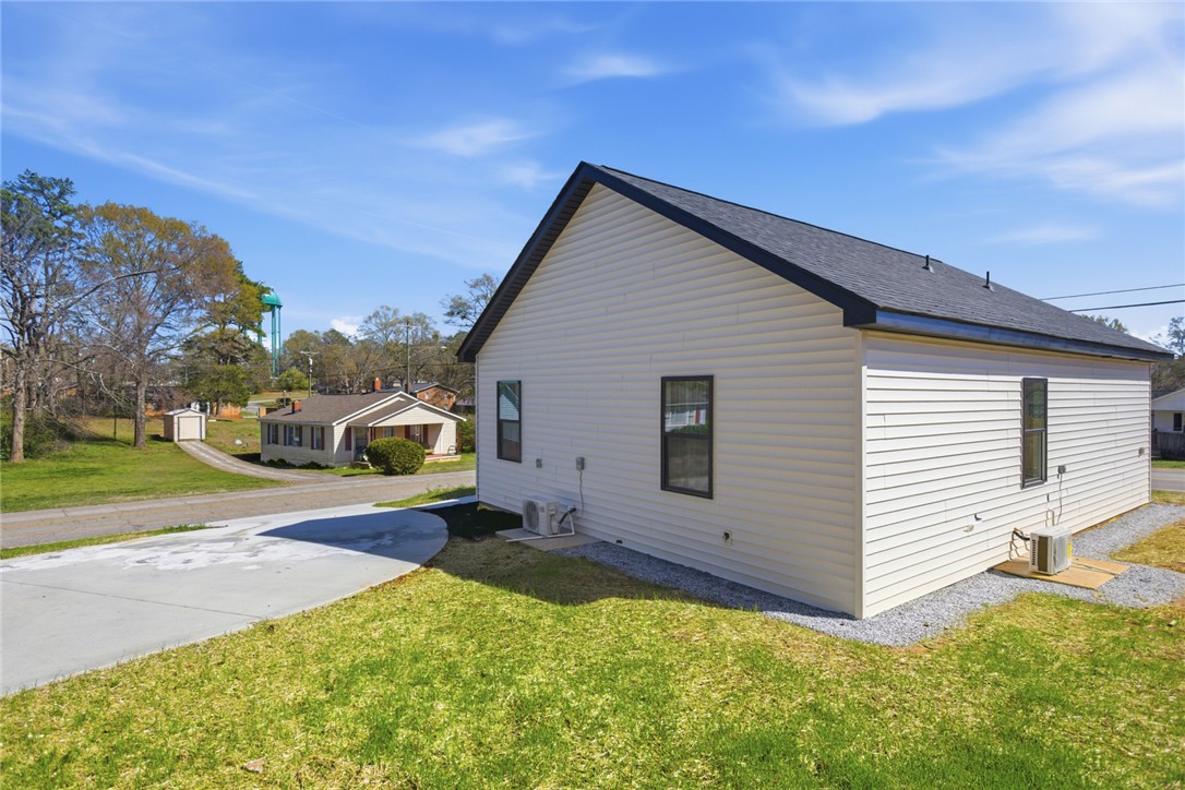 216 South Stribling Street Seneca, SC 29678 - Photo 4 of 38 This newly constructed home features a pristine exterior with ample green space and a paved driveway.