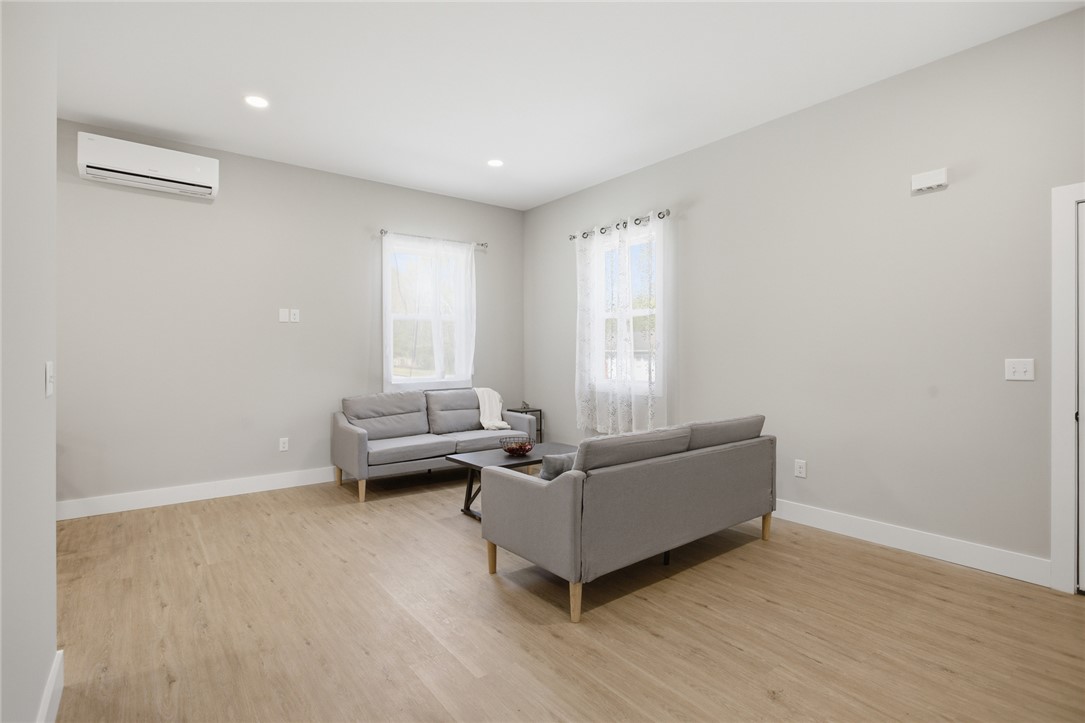 216 South Stribling Street Seneca, SC 29678 - Photo 8 of 38 This living room features ample natural light and durable flooring, creating an inviting atmosphere.