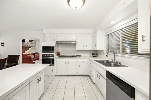 a bathroom with a granite countertop sink a toilet and a mirror