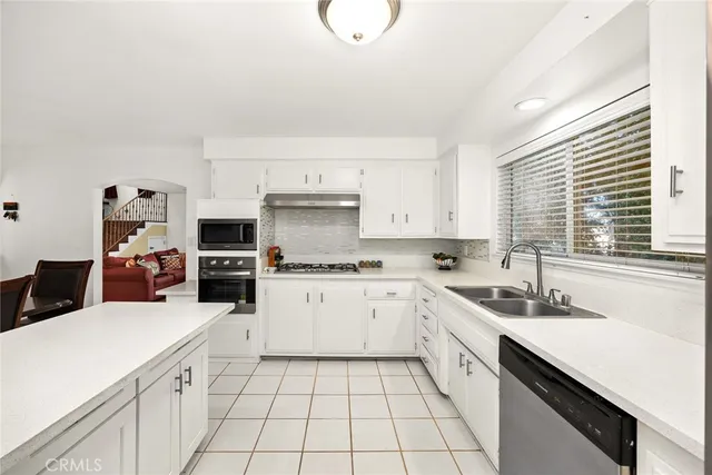 a bathroom with a granite countertop sink a toilet and a mirror