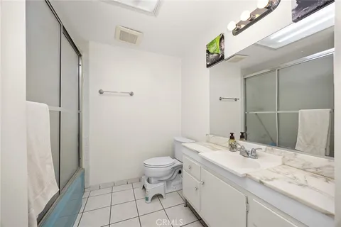 a bedroom with bed and a window