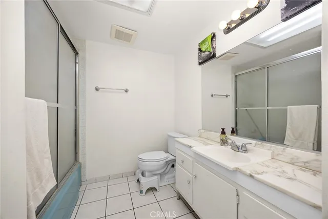 a bedroom with bed and a window