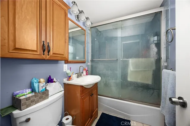 a bedroom with bed couch and window