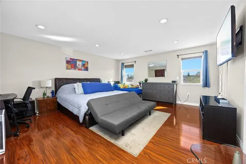 a bedroom with a bed and a large window