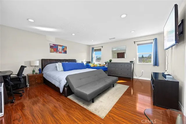 a bedroom with a bed and a large window