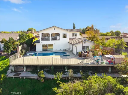 a view of a white house with a yard and furniture