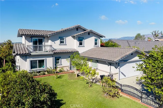 a aerial view of a house with swimming pool and a yard