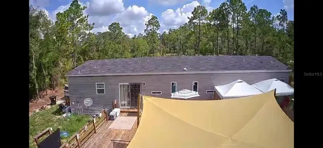 a kitchen with stainless steel appliances a dining table chairs and a refrigerator