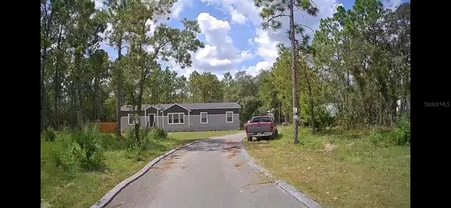 a view of a house with a small yard