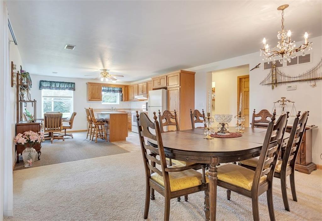 1130 Ridge Road Templeton, PA 16259 - Photo 7 of 25 a dining room with furniture a chandelier and wooden floor