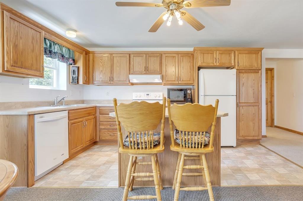 1130 Ridge Road Templeton, PA 16259 - Photo 9 of 25 a kitchen with stainless steel appliances granite countertop a table chairs and a refrigerator