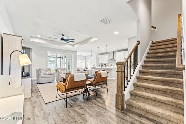 a living room with lots of furniture and a wooden floor